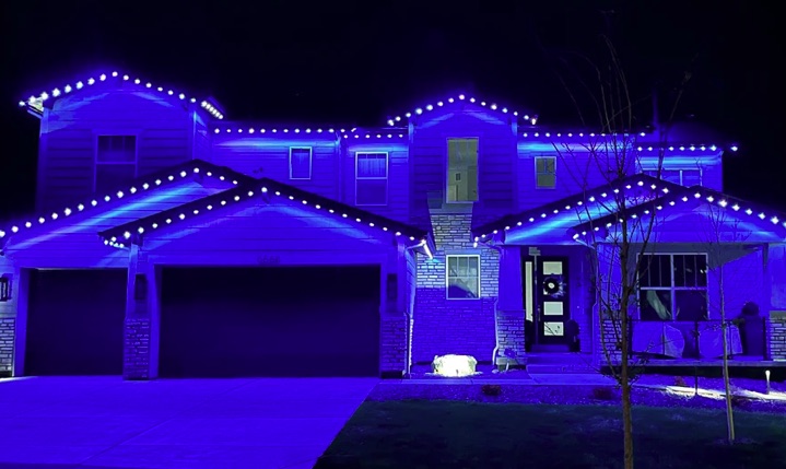 Minleon RGBW+2 track-mounted permanent lights on a home roofline
