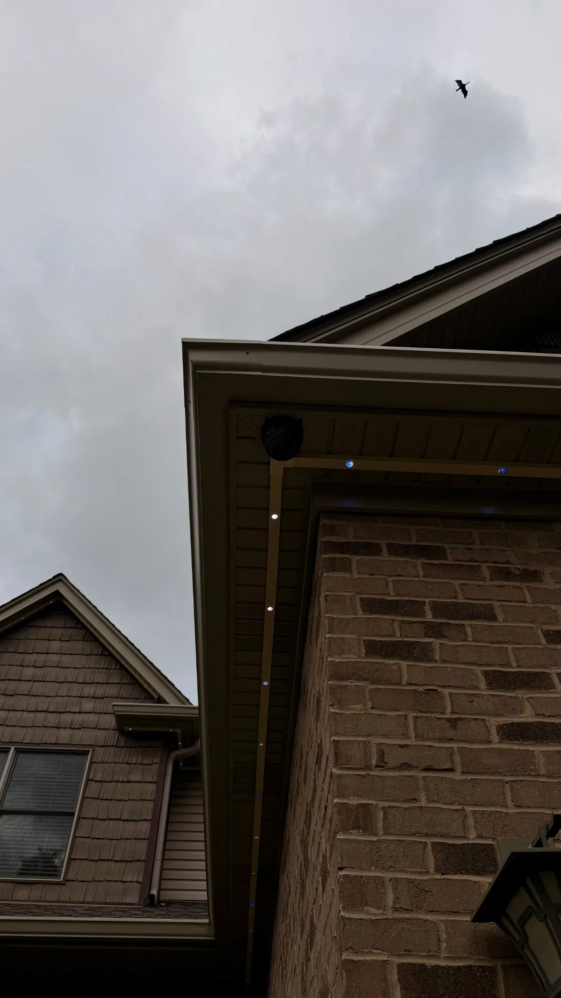 SnapTrack Govee roofline lights on brick home corner — snap-on aluminum channel soffit mount installation — First Frost IL