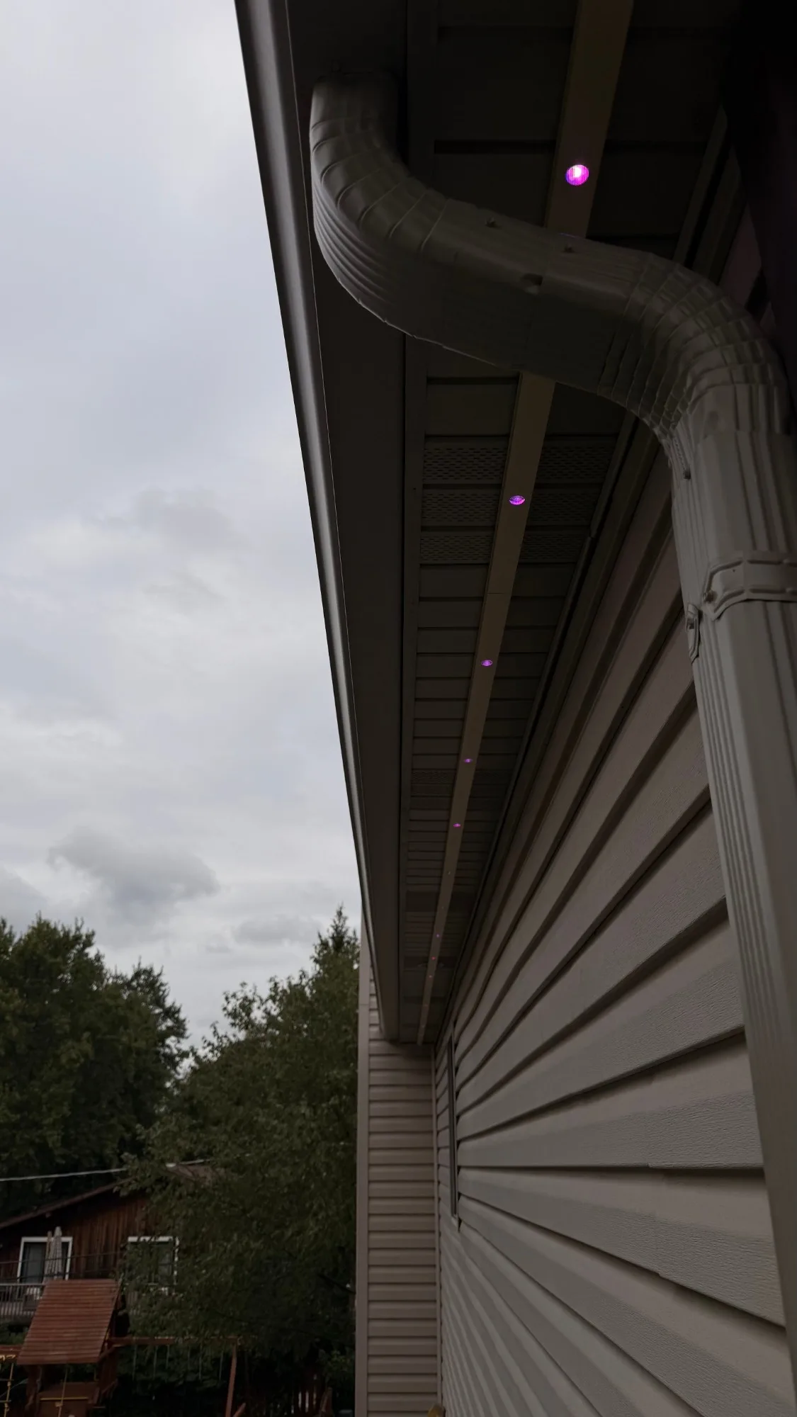 Govee permanent outdoor lights in white SnapTrack soffit channel — invisible hardware in daylight — First Frost Chicagoland IL